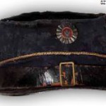 czapka Kepi oficera żuawów śmierci z ciemnogranatowego sukna, na denku czterolistne naszycie ze złotego galonu, dookoła otoku złoty galon, daszek skórzany, z przodu przymocowana metalowa kokarda pokryta czerwoną emalią ze srebrnym Orłem. Kepi po poruczniku Antonim Ryszardzie